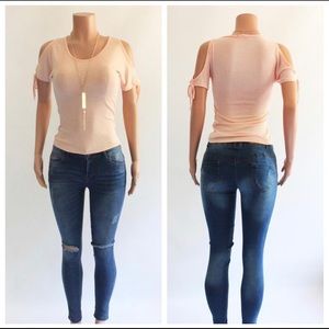 Pink blush top with cold shoulders. Includes necklace